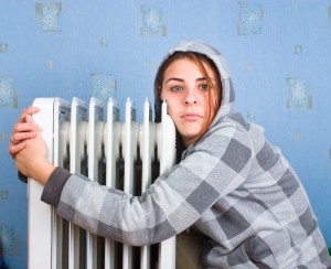 The freezing girl about a heater