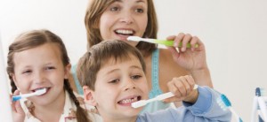 Mother and children brushing teeth