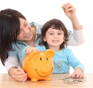 2 years old girl with her mother and piggy bank isolated on white