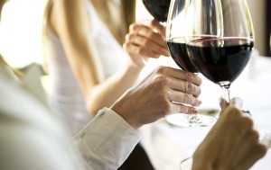 Young woman raising glasses with red wine, Canon 1Ds mark III