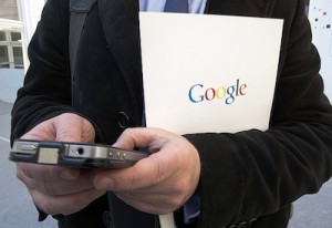 FILE - In this Dec.10 2013 file photo, a reporter uses his phone during a presentation for the new Google cultural institute in Paris, France. France's data privacy regulator has rejected Monday Sept.21, 2015 Google's appeal of an order to remove search results worldwide upon request. (AP Photo/Jacques Brinon, File)